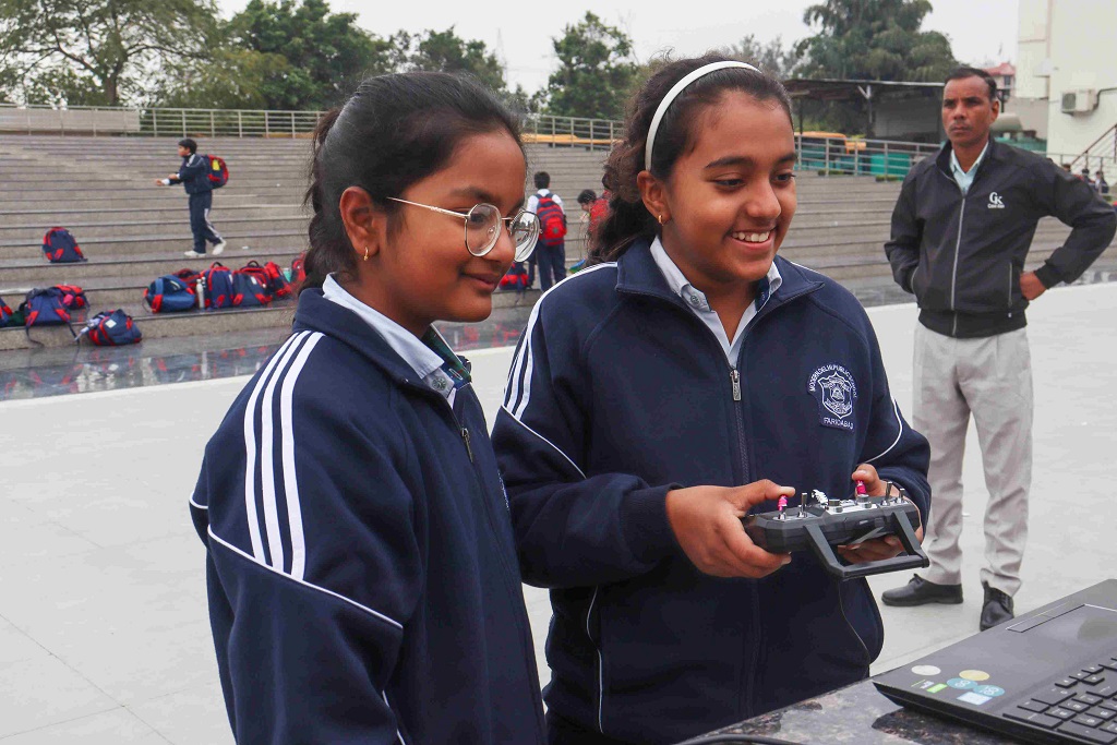Students actively engaged in hands-on drone flying