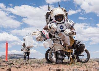 NASA astronaut Andre Douglas collects soil samples during the first in a series of four simulated moonwalks in the San Francisco Volcanic Field in Norther Arizona