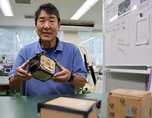 Takao Doi, a former Japanese astronaut and professor at Kyoto University, holds an engineering model of LignoSat during an interview with Reuters at his laboratory at Kyoto University in Kyoto, Japan, October 25, 2024. (Image Credit: REUTERS/Irene Wang/File Photo)