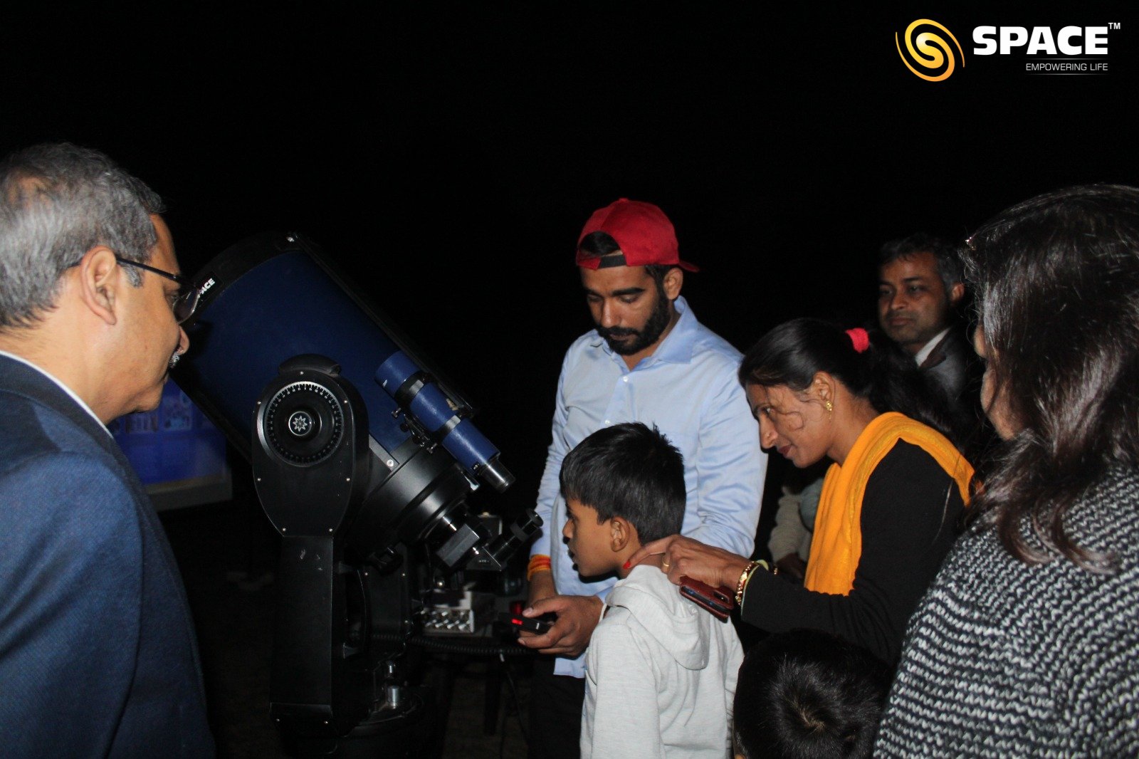 Parents and Children observing planets with Meade Telescope