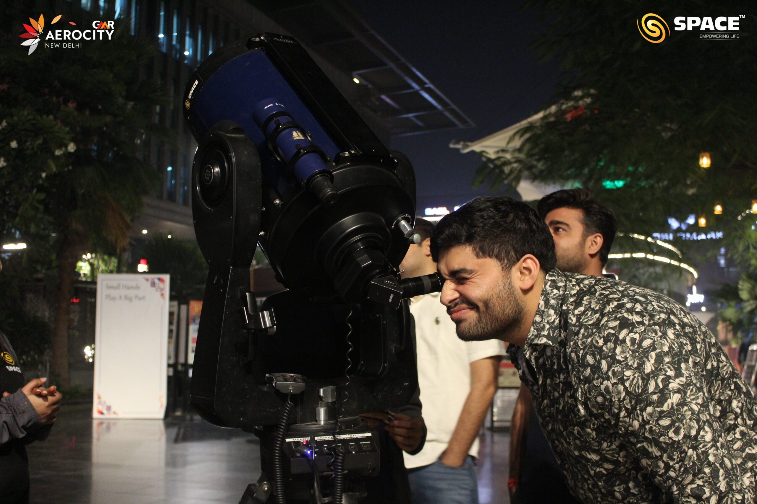 People observing saturn through Meade Telescope